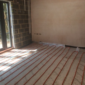 Underfloor heating pipes laid onto insulation and prior to screeding