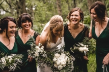 Bride and bridesmaids enjoying the moment at a woodland wedding